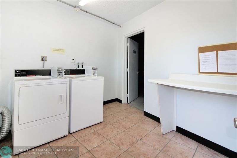 1055 Cambridge C, Unit 1055 Deerfield Beach, FL 33442 - Photo 26 of 52 a utility room with dryer and washer