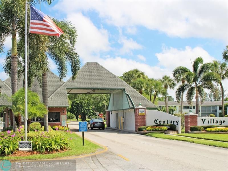1055 Cambridge C, Unit 1055 Deerfield Beach, FL 33442 - Photo 30 of 52 a front view of a house with a garden and trees