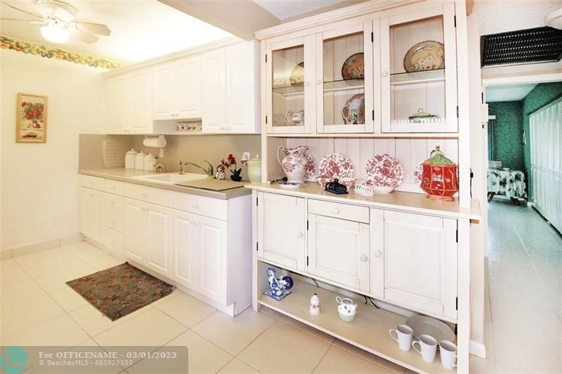 1055 Cambridge C, Unit 1055 Deerfield Beach, FL 33442 - Photo 9 of 52 a kitchen with stainless steel appliances cabinets and a window