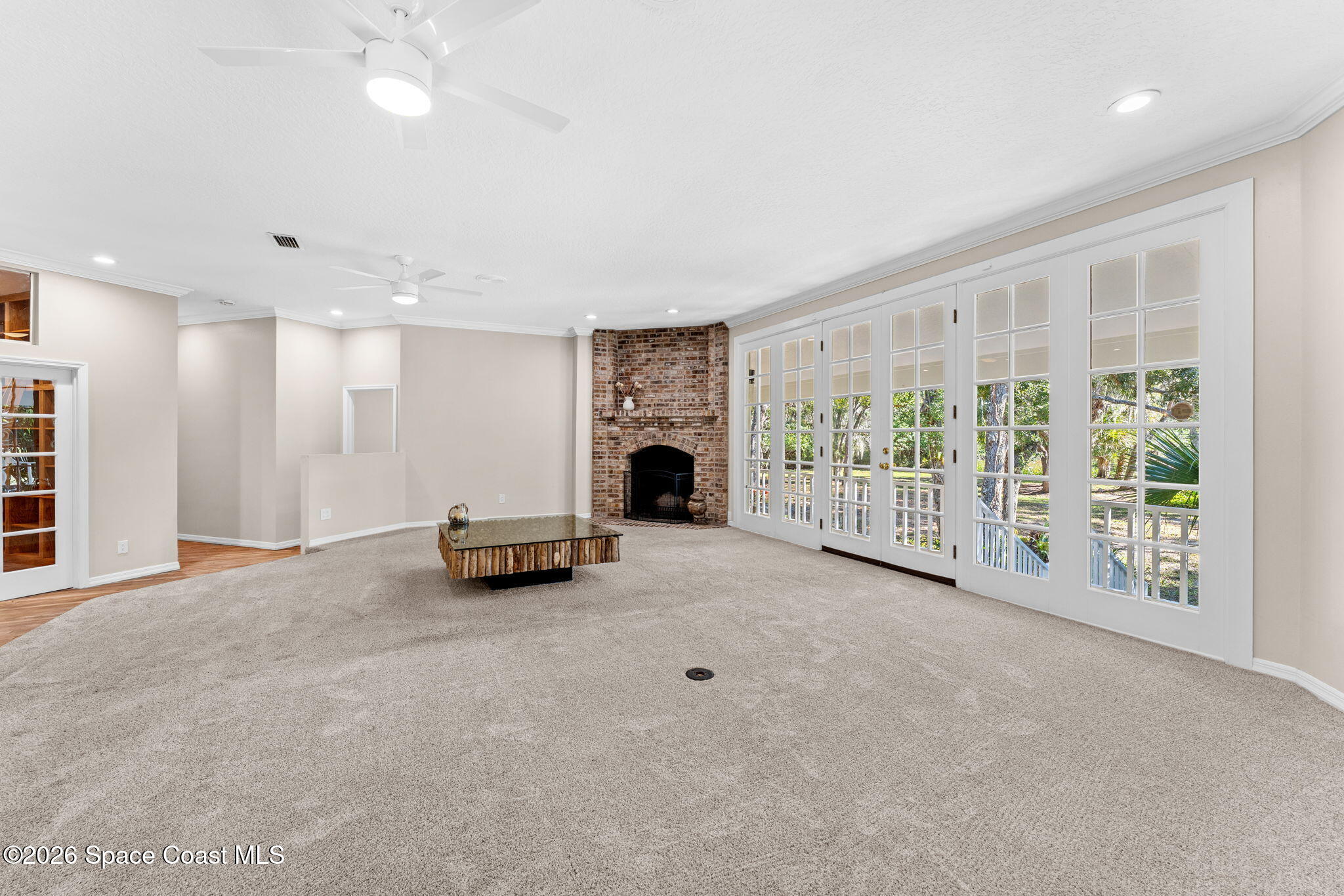 1325 Chase Hammock Road Merritt Island, FL 32953 - Photo 11 of 83 a view of an empty room with a fireplace and a window