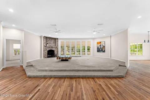 a large kitchen with granite countertop a large window and white appliances