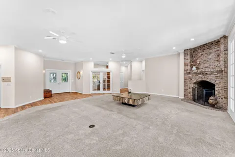 a large white kitchen with granite countertop a stove a sink and a refrigerator