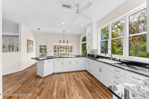 a large kitchen with kitchen island lots of counter space and a window