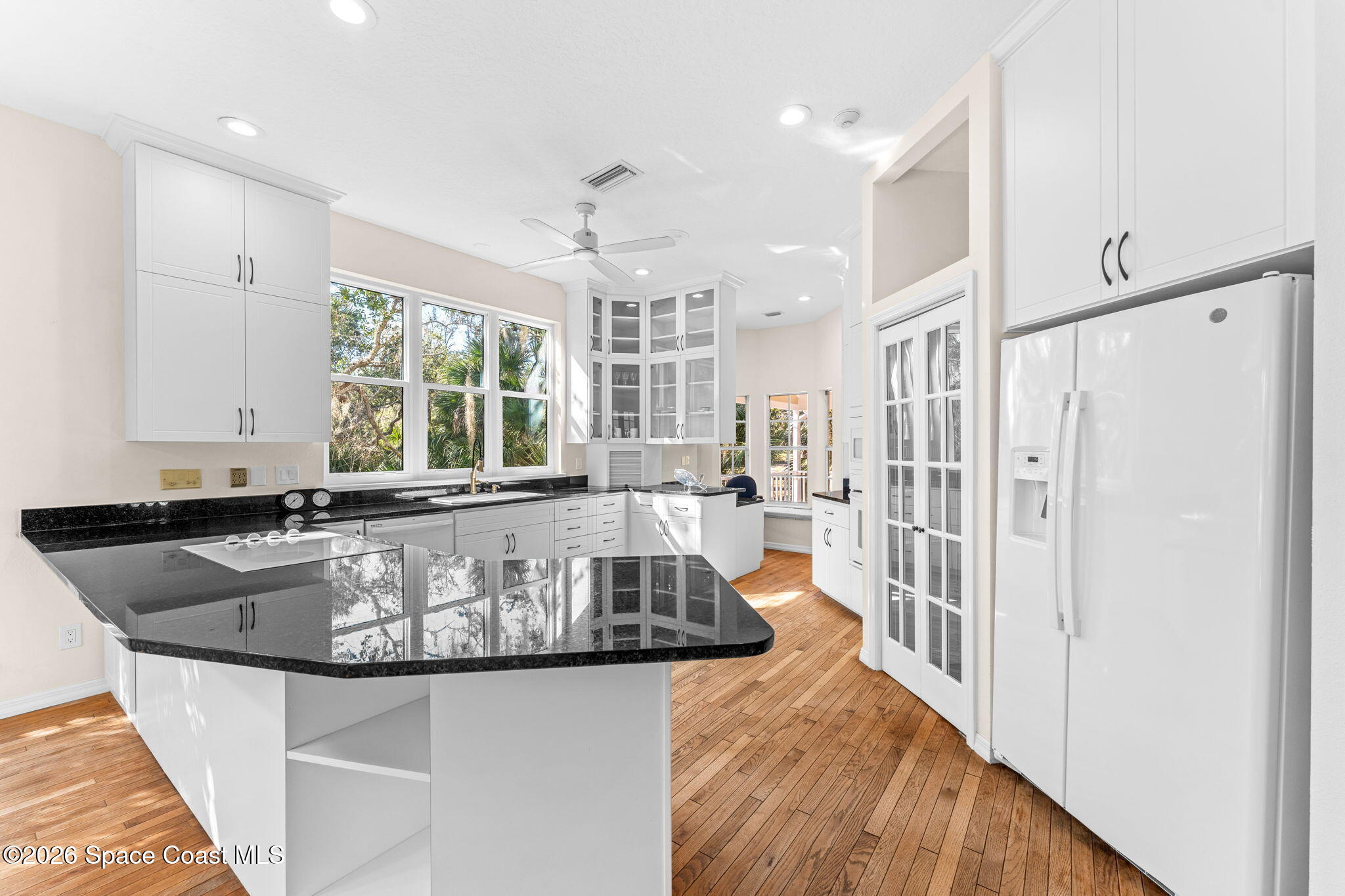 1325 Chase Hammock Road Merritt Island, FL 32953 - Photo 19 of 83 a kitchen with stainless steel appliances granite countertop a sink a stove and a refrigerator