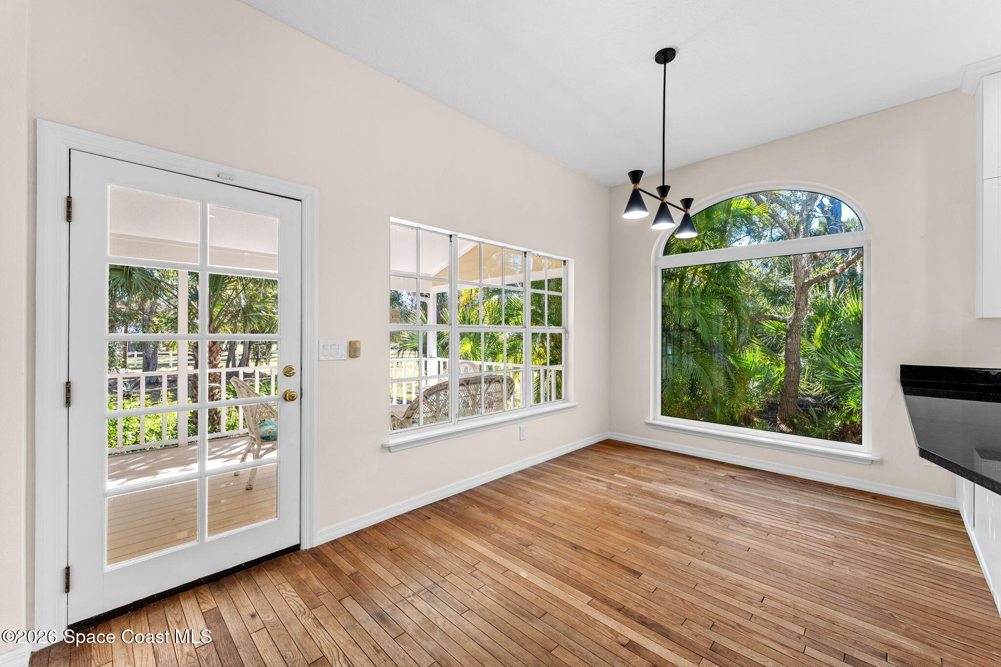 1325 Chase Hammock Road Merritt Island, FL 32953 - Photo 24 of 83 a view of an empty room with wooden floor and a window