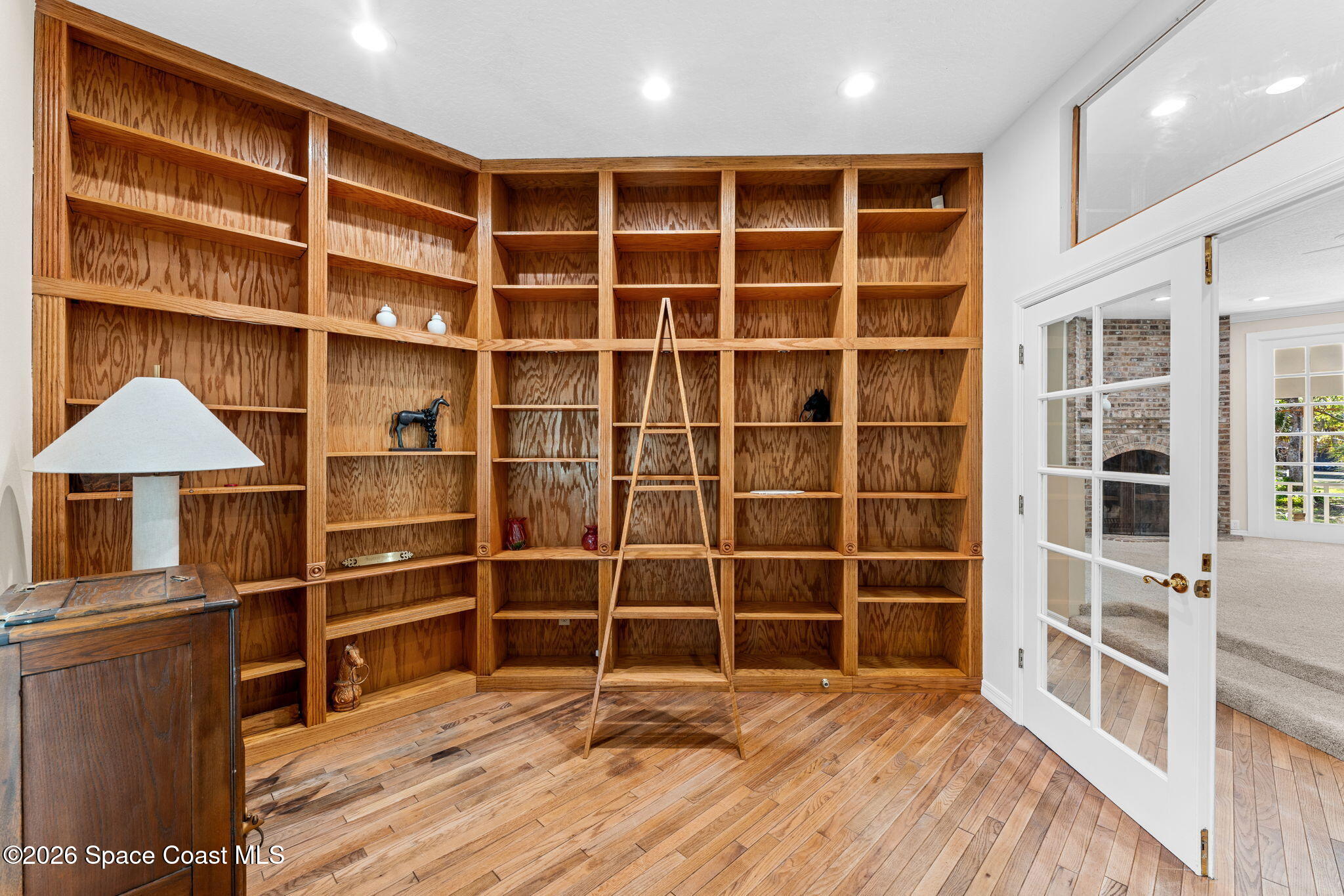 1325 Chase Hammock Road Merritt Island, FL 32953 - Photo 27 of 83 a view of an empty room with a wooden floor and a window