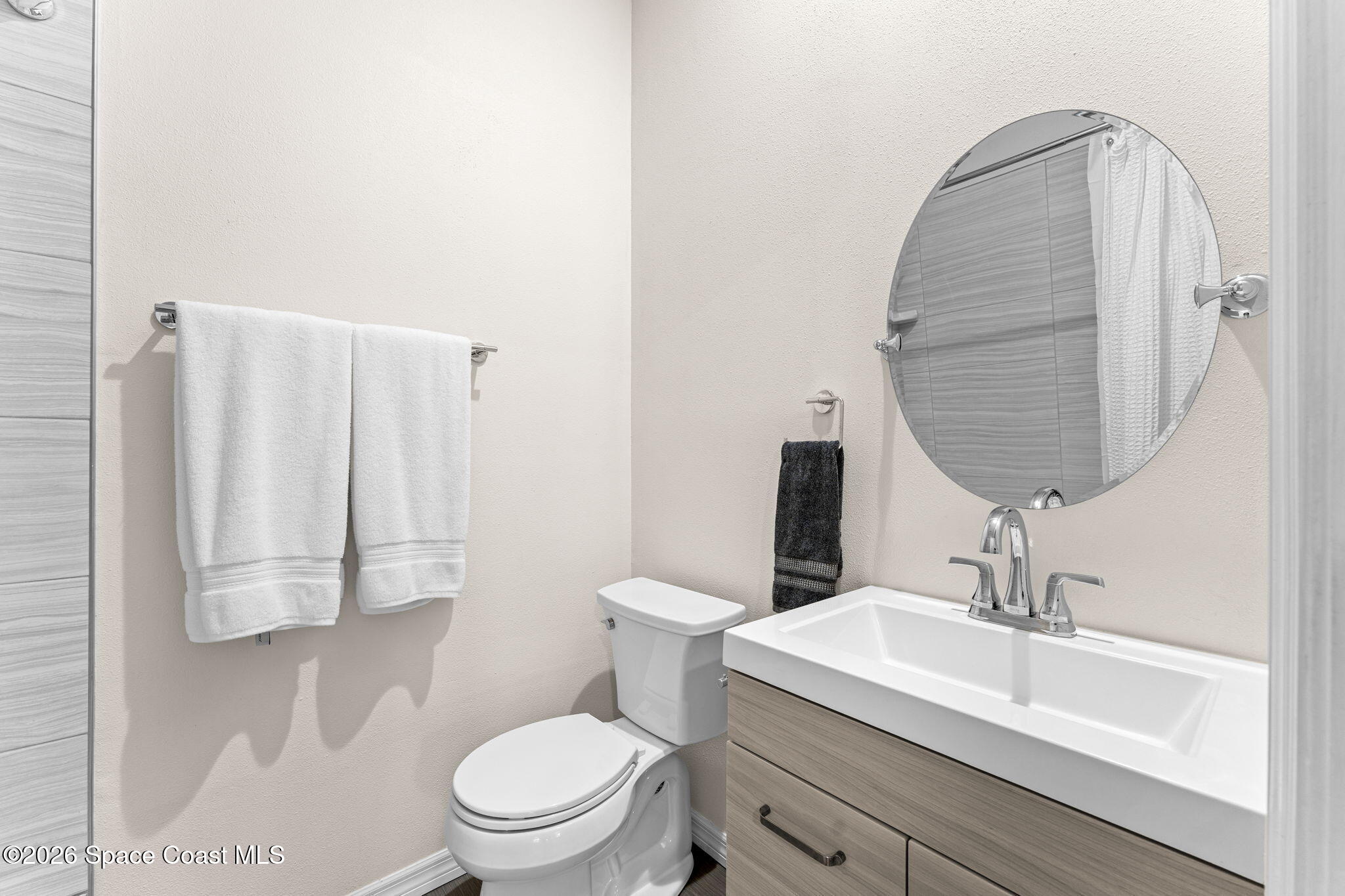 1325 Chase Hammock Road Merritt Island, FL 32953 - Photo 32 of 83 a bathroom with a sink toilet and mirror