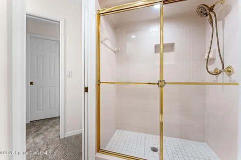 a view of a swimming pool with table and chairs under an umbrella