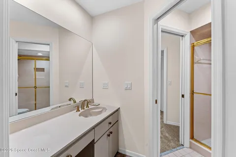 a view of a house with a swimming pool and a large tree