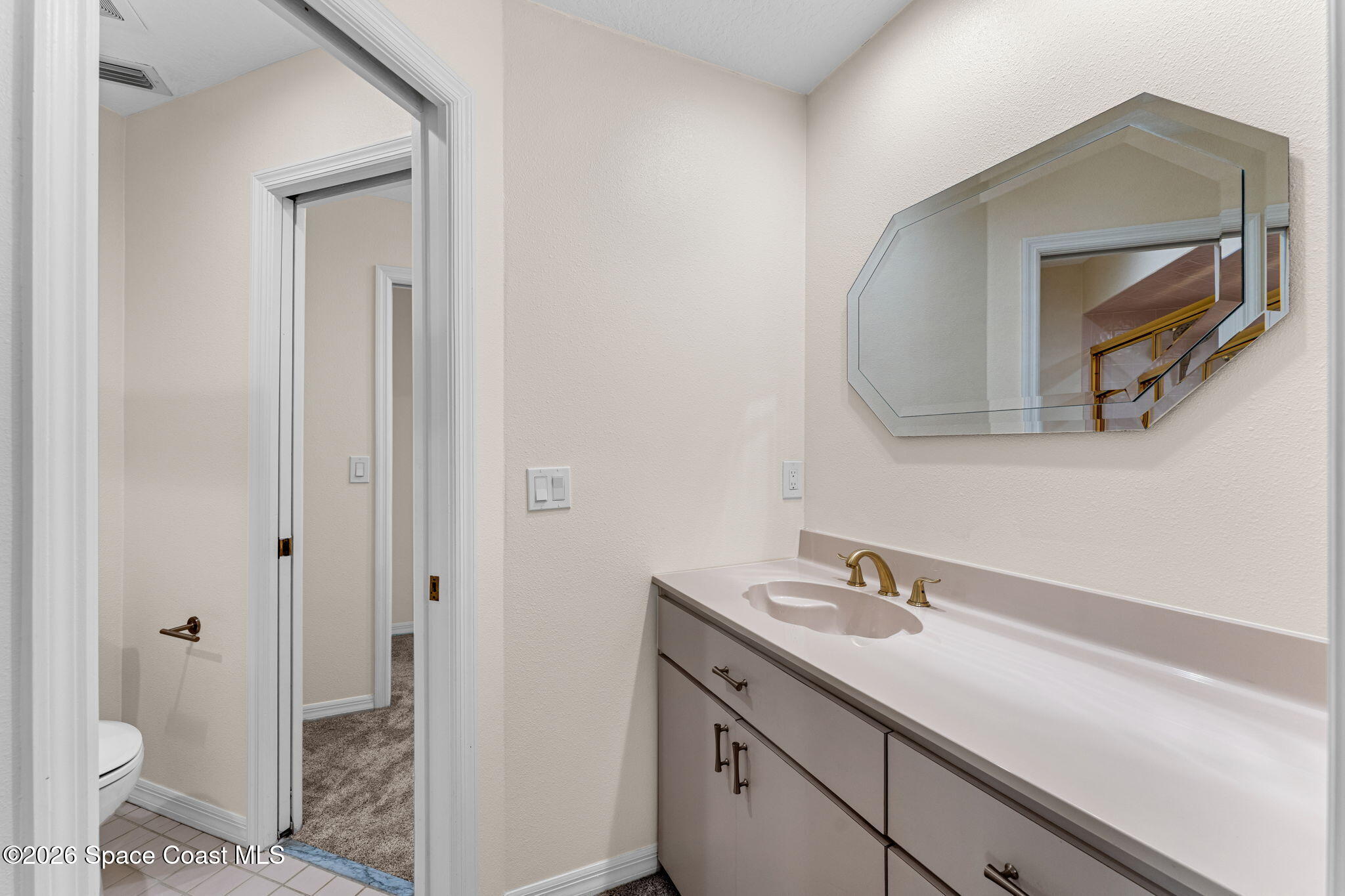 1325 Chase Hammock Road Merritt Island, FL 32953 - Photo 47 of 83 a bathroom with a sink a toilet and a mirror