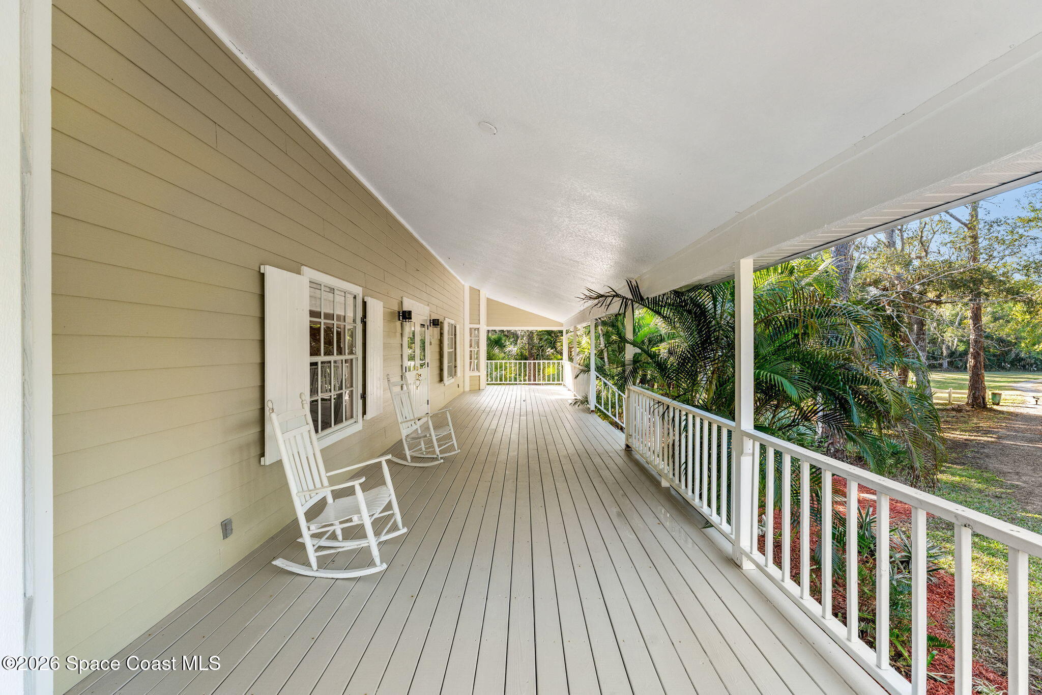 1325 Chase Hammock Road Merritt Island, FL 32953 - Photo 54 of 83 a view of a patio with table and chairs and wooden floor