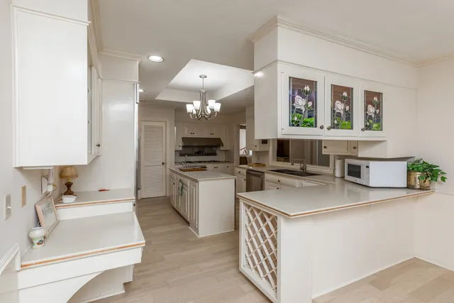a kitchen with a sink cabinets and window