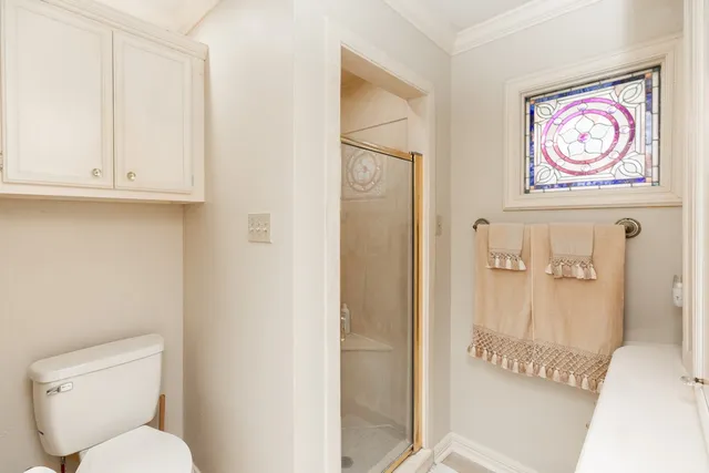 a bathroom with a toilet and a shower