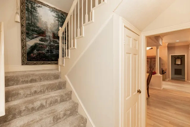 a view of a hallway with wooden floor and entryway