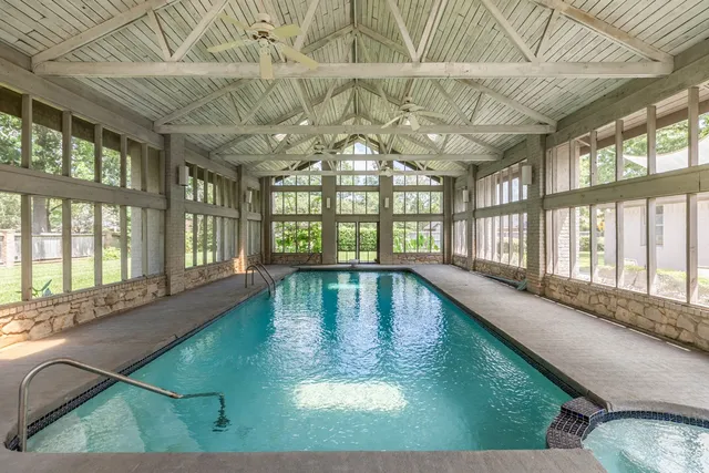 a view of a large pool with a outdoor seating