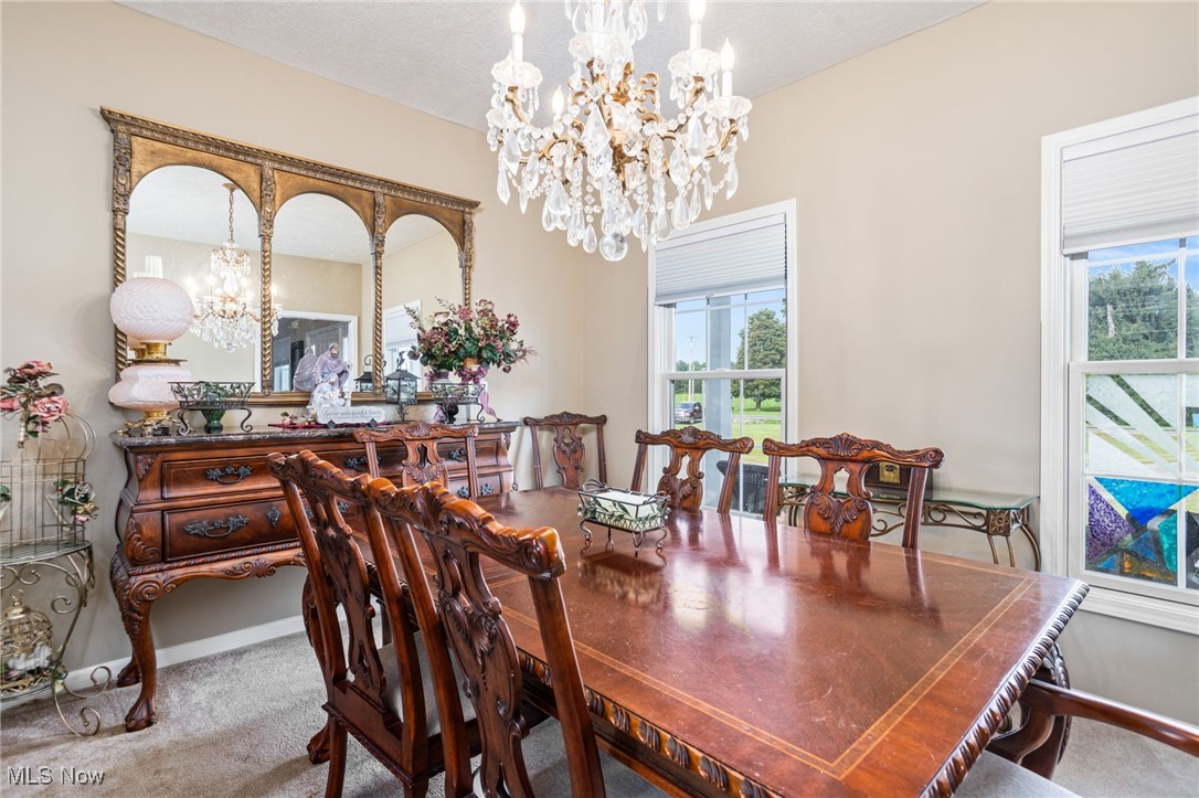 11620 Friendsville Road Creston, OH 44217 - Photo 17 of 40 Dining room with a chandelier and carpet flooring