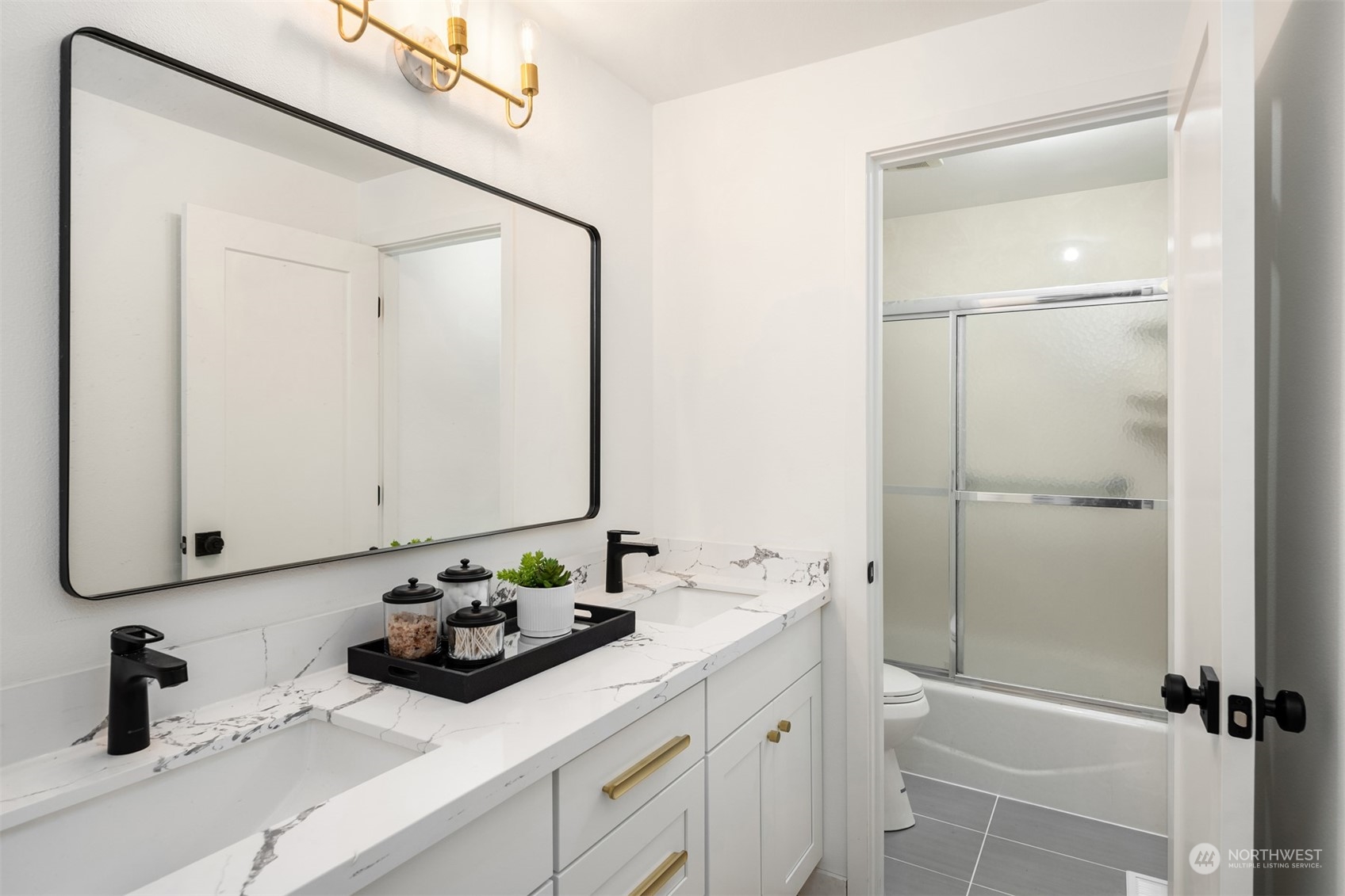2375 Northeast 90th Street Seattle, WA 98115 - Photo 14 of 27 a bathroom with a sink a toilet and shower