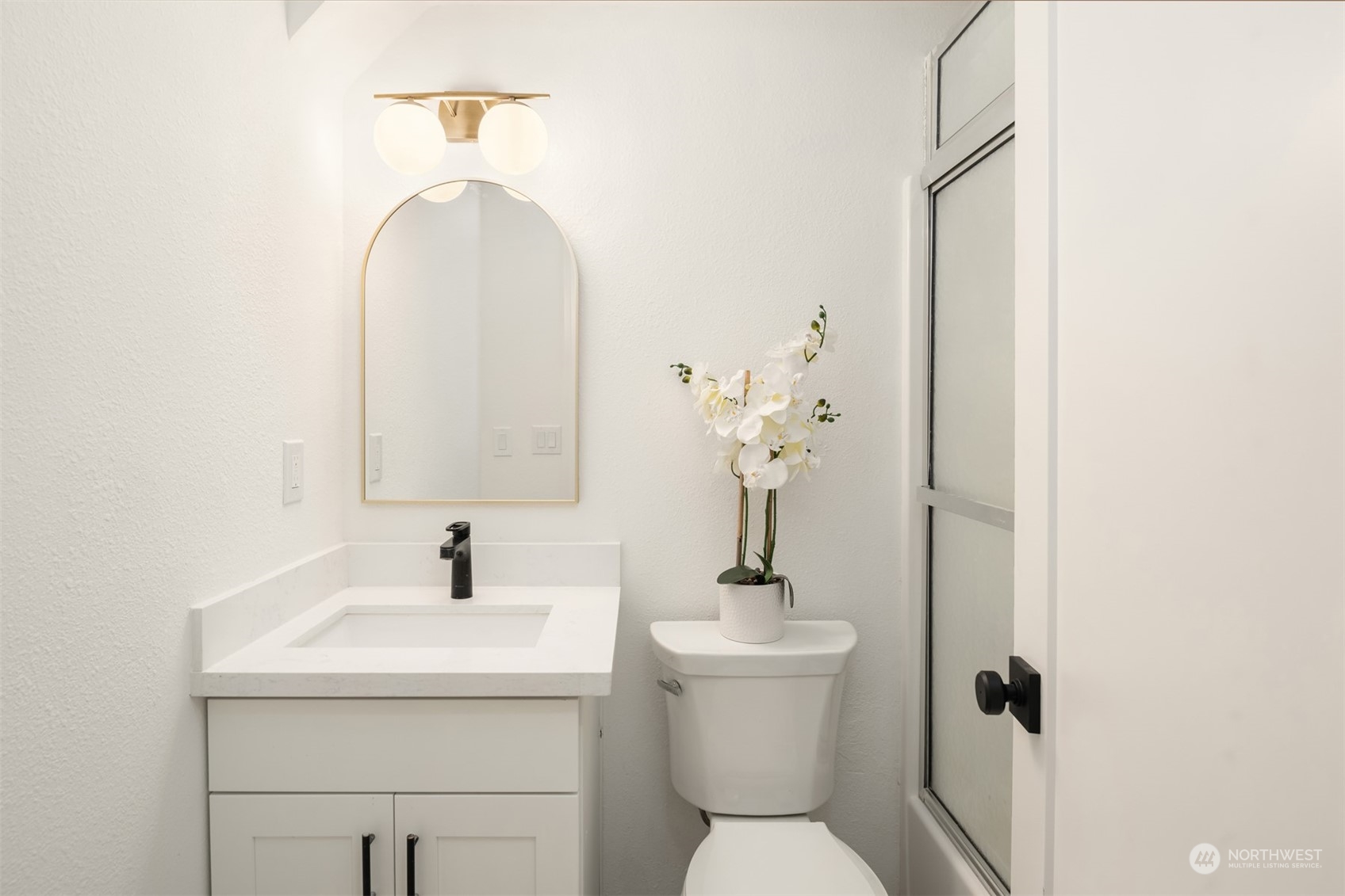2375 Northeast 90th Street Seattle, WA 98115 - Photo 24 of 27 a bathroom with a toilet sink and mirror
