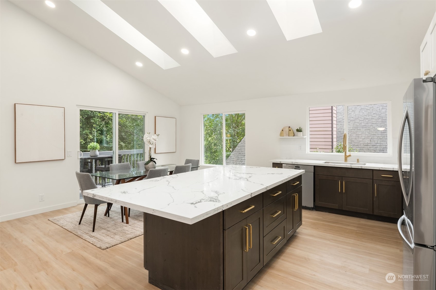2375 Northeast 90th Street Seattle, WA 98115 - Photo 10 of 27 a kitchen with a stove a sink a dining table and chairs