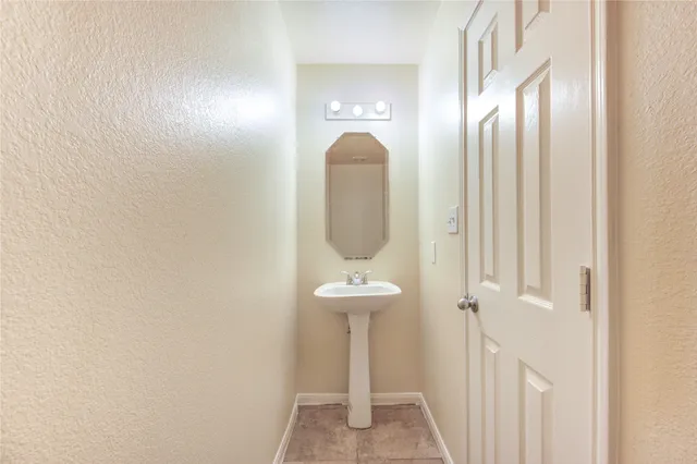a bathroom with a mirror and a sink