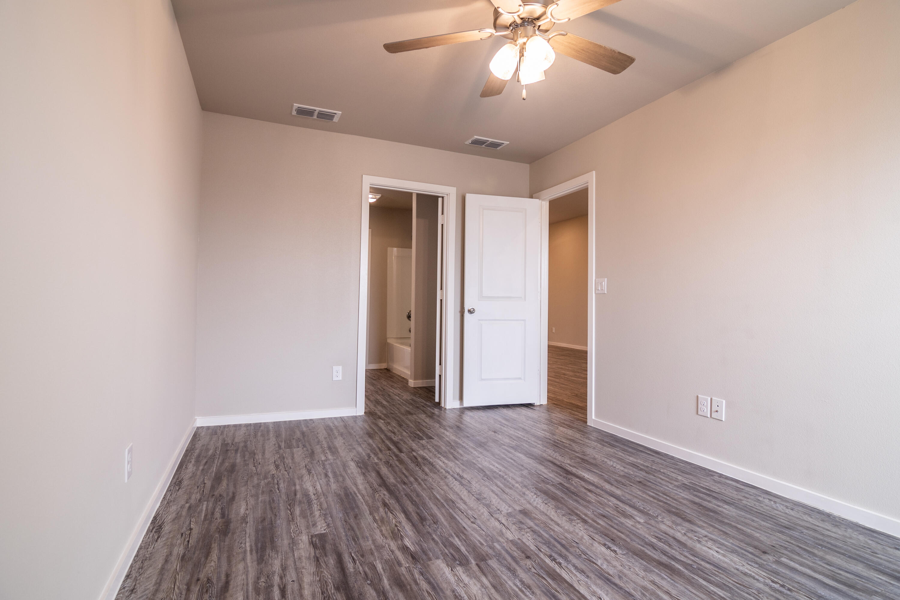2118 Langford Avenue, Unit B Lubbock, TX 79407 - Photo 11 of 19 an empty room with wooden floor and windows