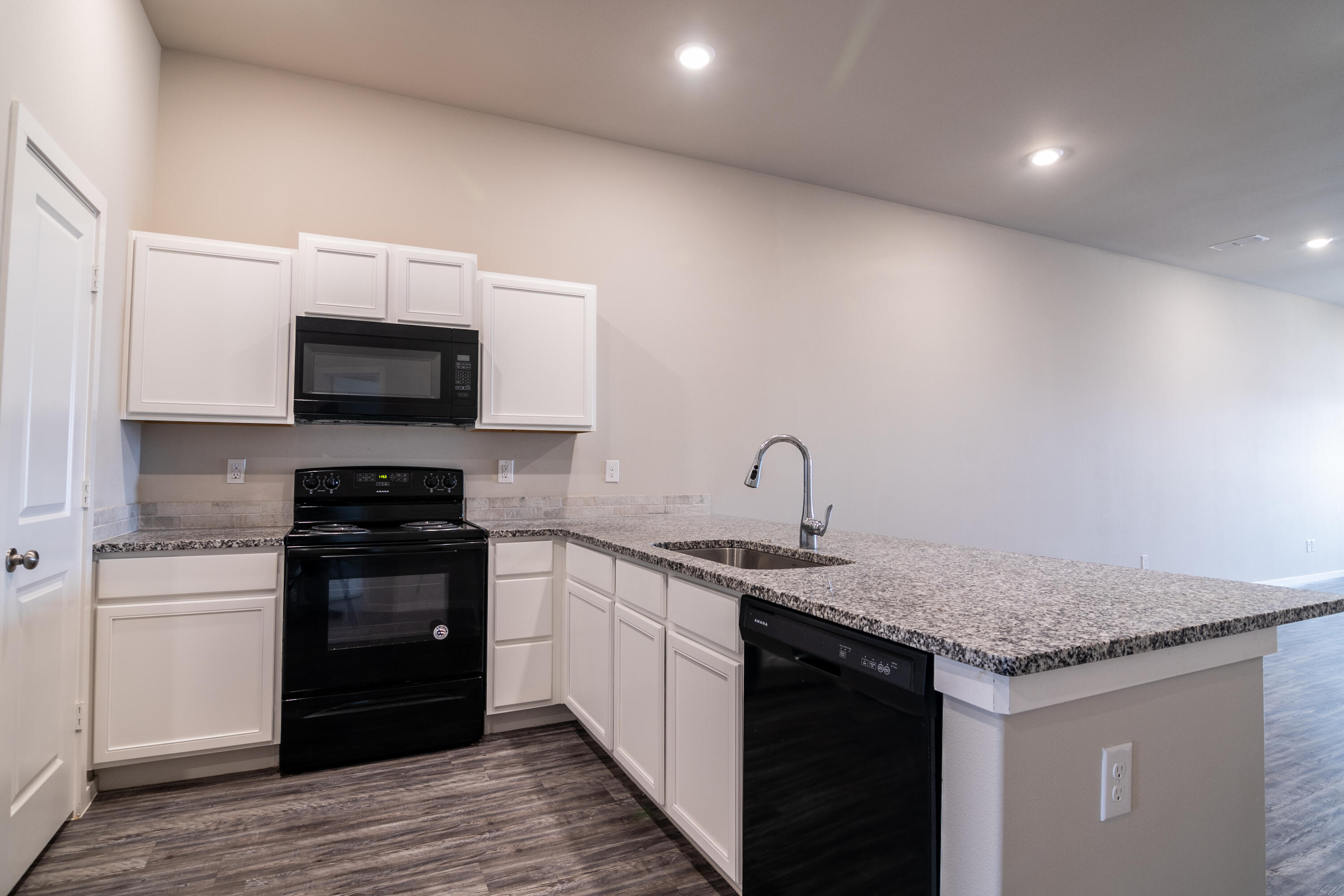 2118 Langford Avenue, Unit B Lubbock, TX 79407 - Photo 16 of 19 a kitchen with stainless steel appliances granite countertop a sink and a stove