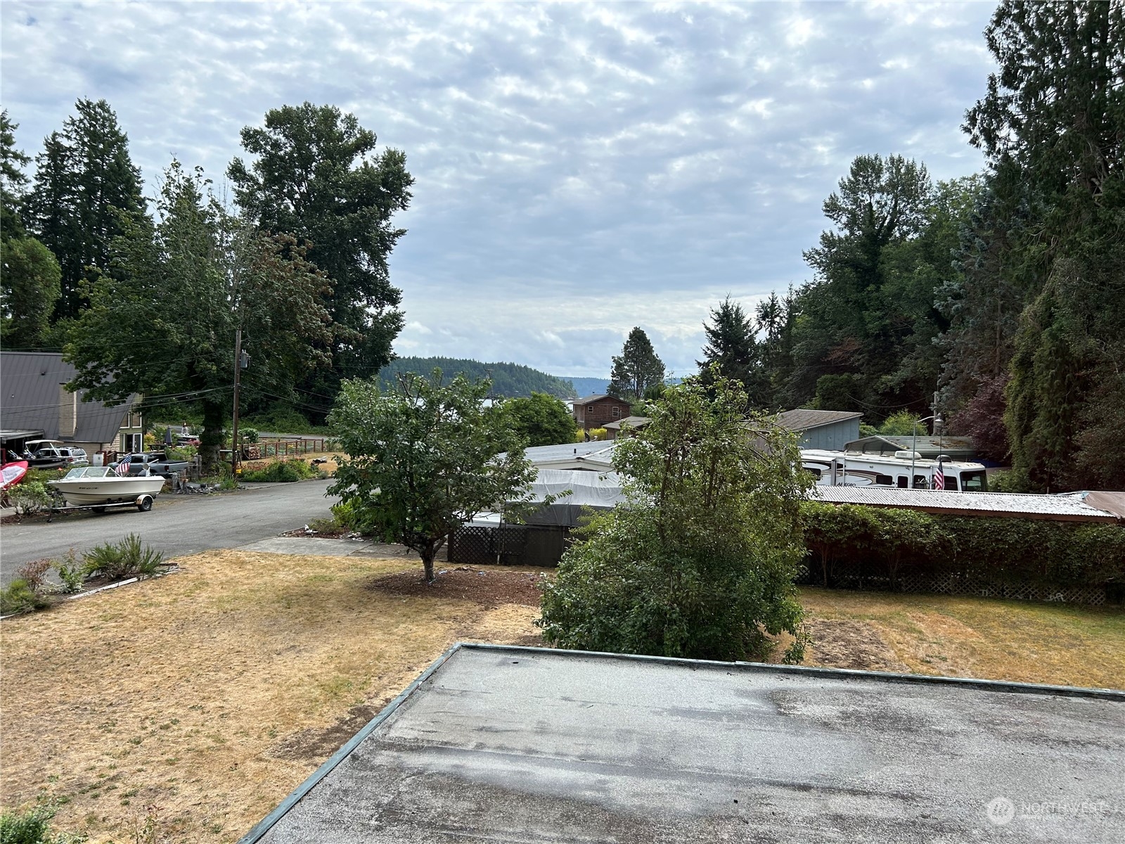 41 Cove Way Brinnon, WA 98320 - Photo 18 of 39 a view of a swimming pool with a bench and trees around
