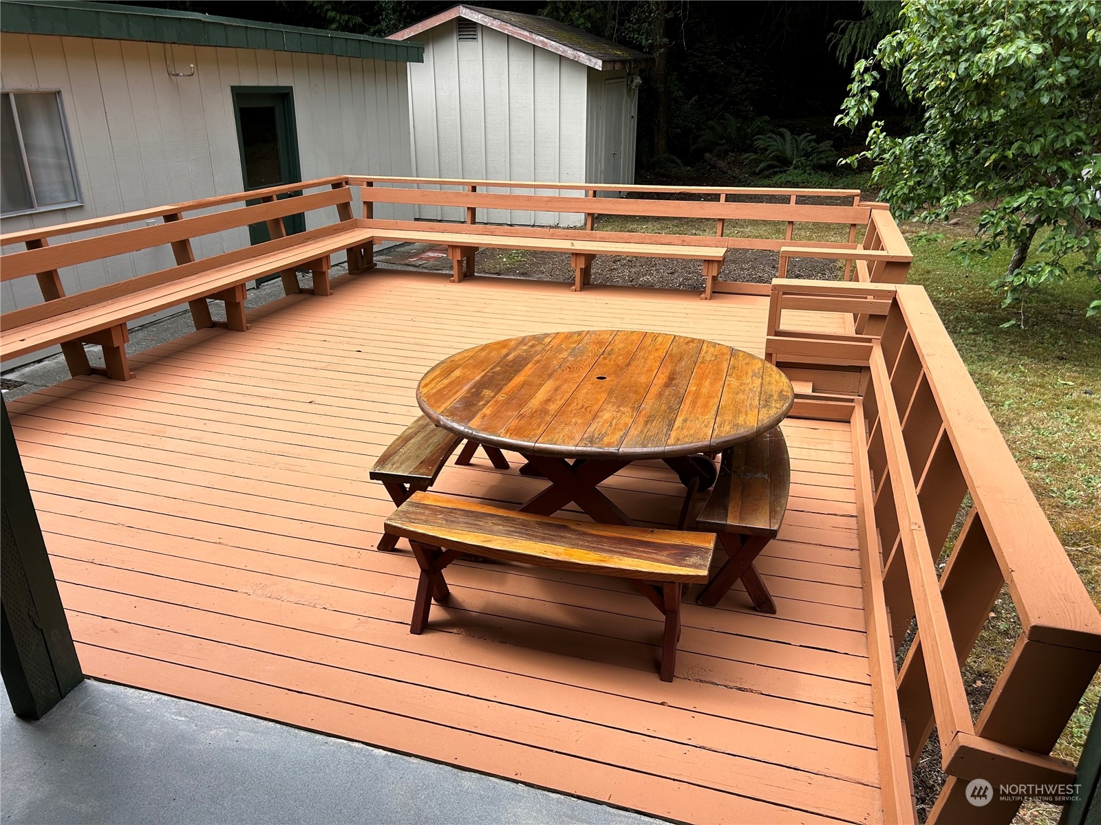 41 Cove Way Brinnon, WA 98320 - Photo 19 of 39 a backyard of a house with wooden floor pool table and chairs