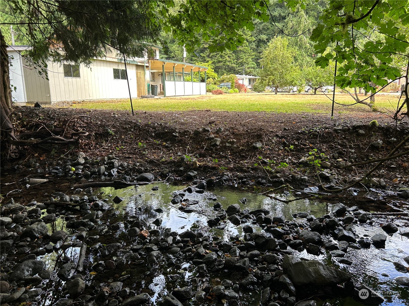 41 Cove Way Brinnon, WA 98320 - Photo 34 of 39 a view of a house with a backyard