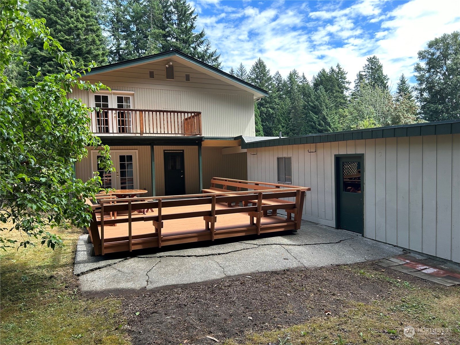 41 Cove Way Brinnon, WA 98320 - Photo 4 of 39 a wooden bench sitting in front of a house