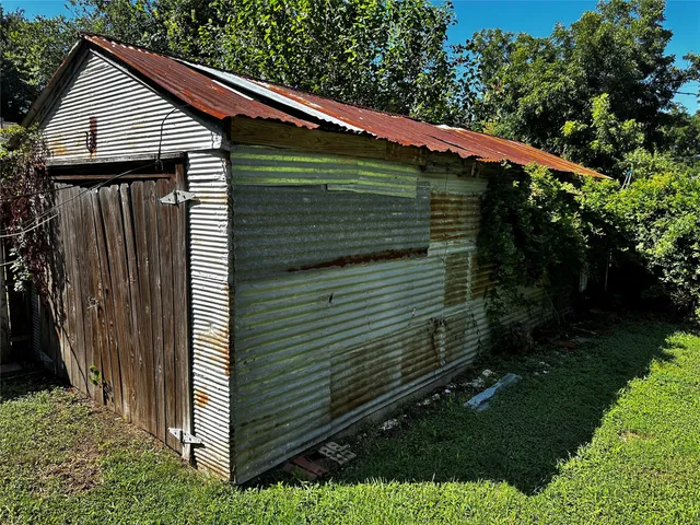 a view of backyard with large trees