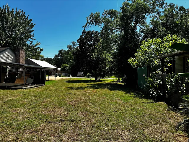 a front view of a house with a tree