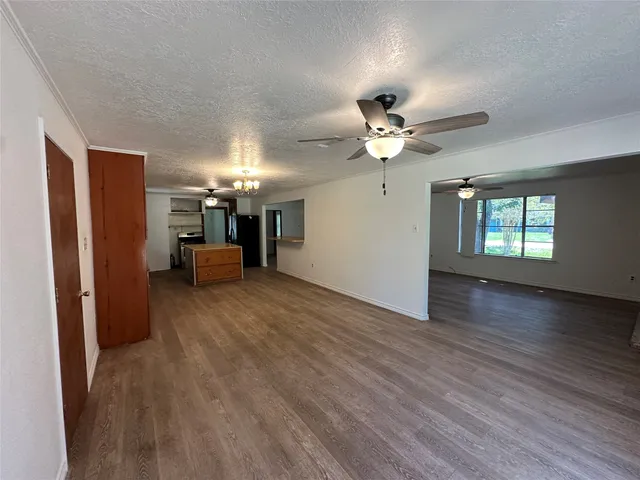 a view of a livingroom with a window and a ceiling fan