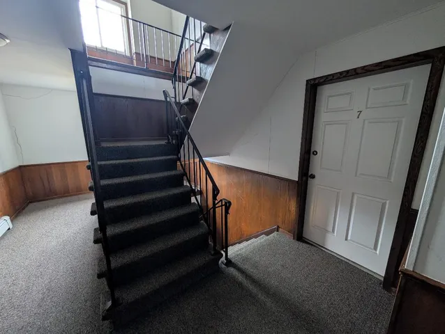 a view of entryway with stairs and wooden floor