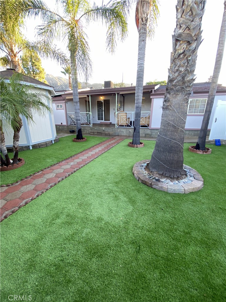 10535 Samoa Avenue Tujunga, CA 91042 - Photo 22 of 25 a view of a house with a yard and palm trees