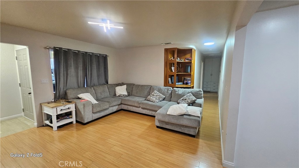 10535 Samoa Avenue Tujunga, CA 91042 - Photo 9 of 25 a living room with furniture and wooden floor