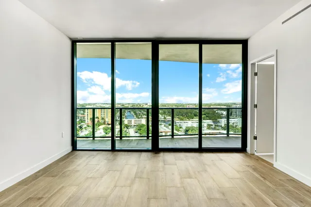 a view of swimming pool with outdoor seating and palm trees