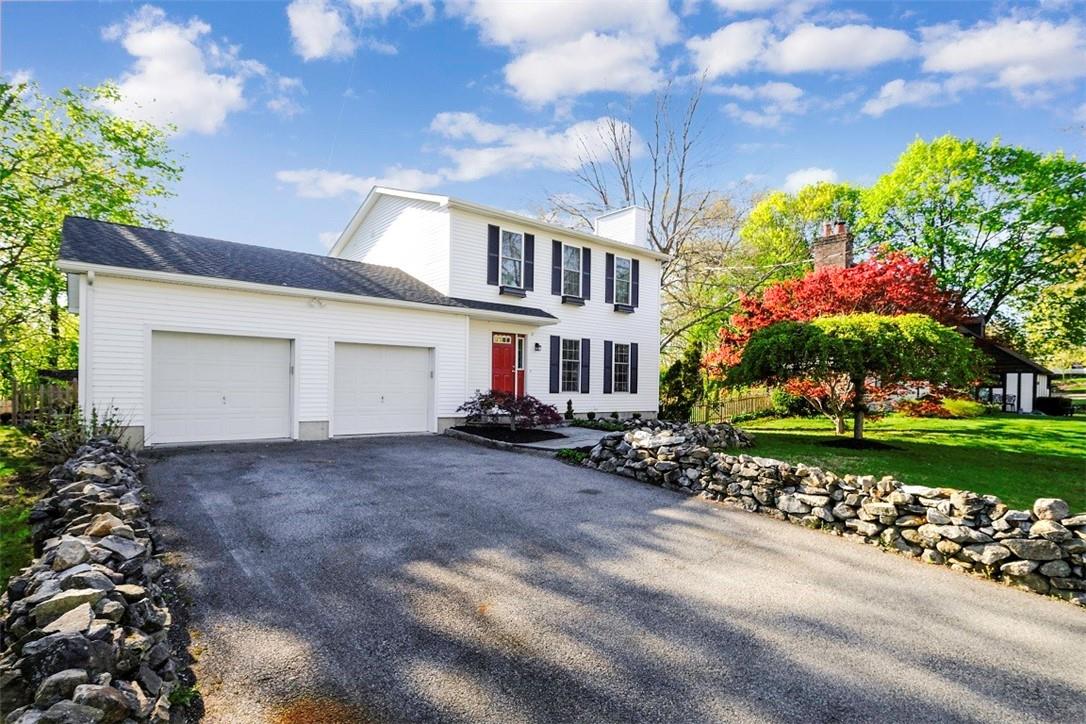 10 Oakridge Parkway Peekskill, NY 10566 - Photo 1 of 1 a front view of a house with a yard and a garage