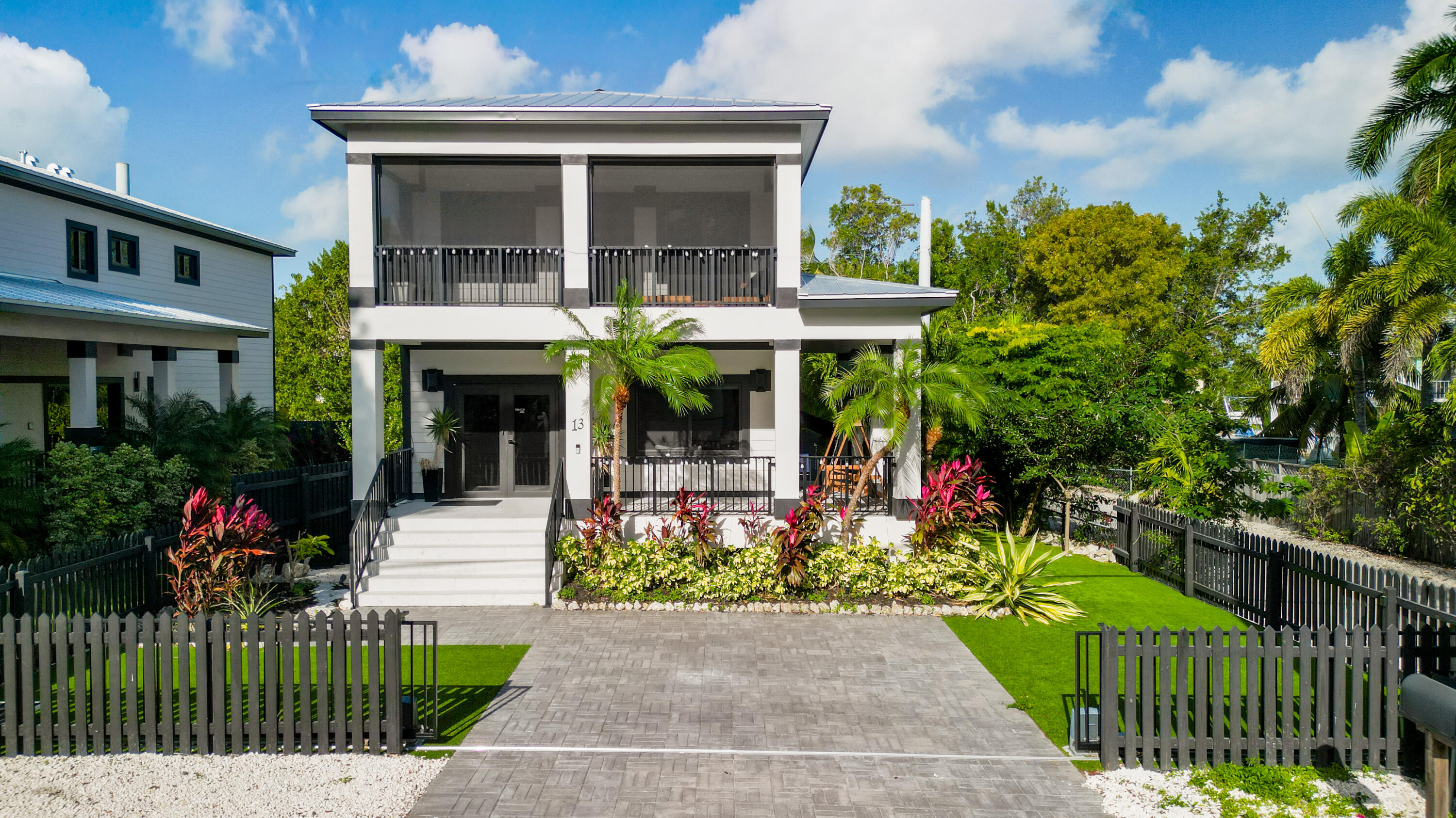 13 Coral Way Key Largo, FL 33037 - Photo 3 of 34 a view of a house with garden and plants