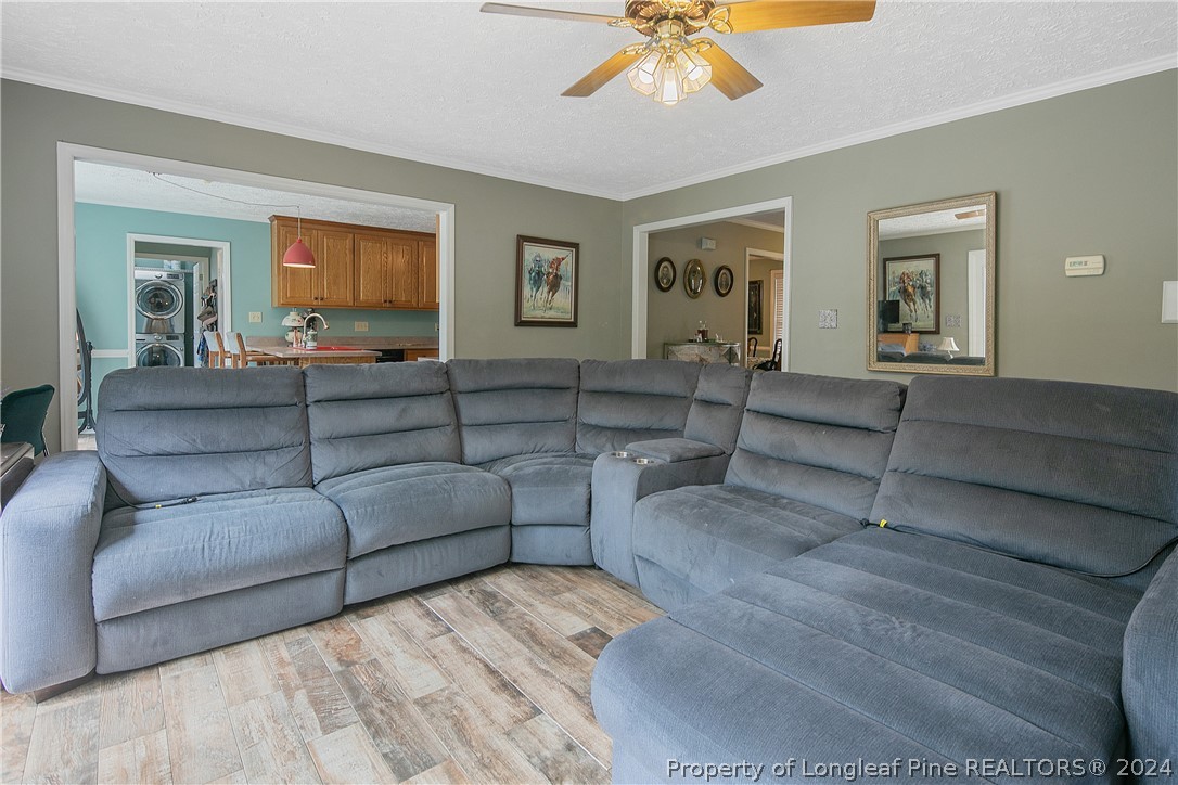 7833 Shuttle Road Fayetteville, NC 28311 - Photo 12 of 46 a living room with furniture and a flat screen tv