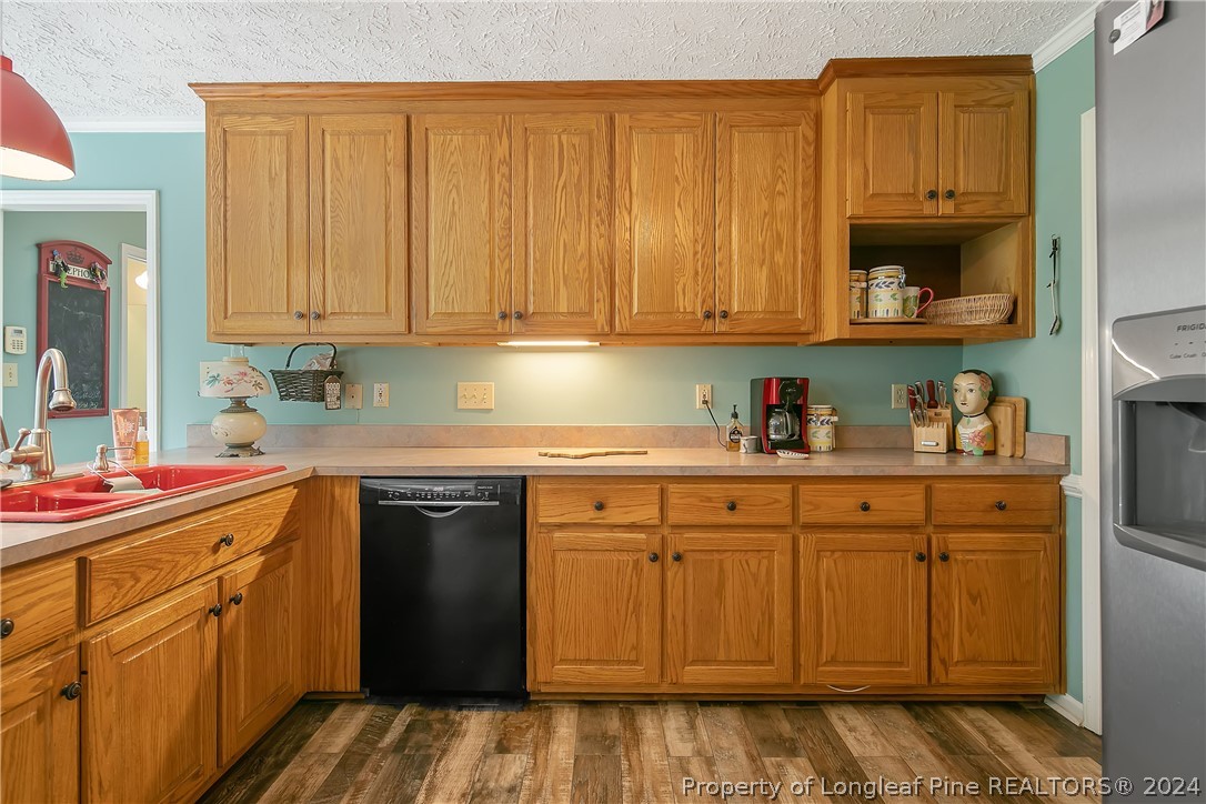 7833 Shuttle Road Fayetteville, NC 28311 - Photo 18 of 46 a kitchen with stainless steel appliances granite countertop a sink stove and cabinets