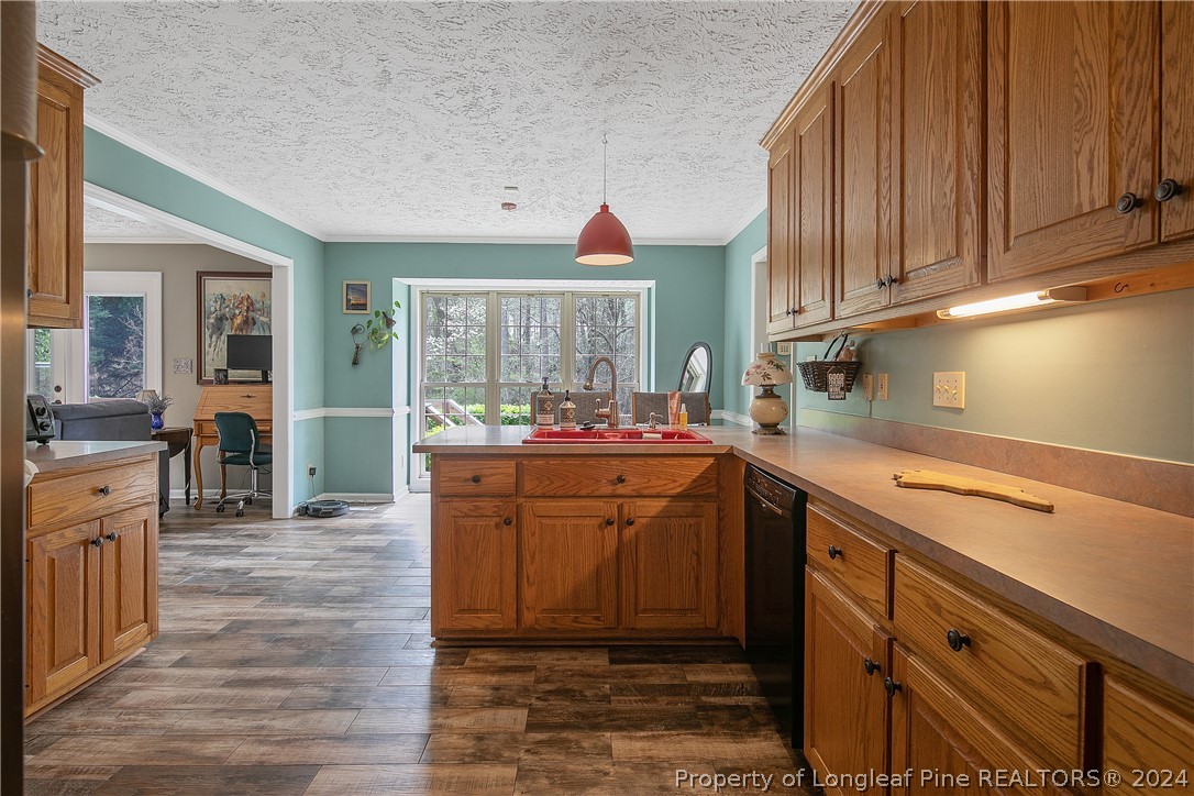 7833 Shuttle Road Fayetteville, NC 28311 - Photo 19 of 46 a kitchen with cabinets a sink and appliances