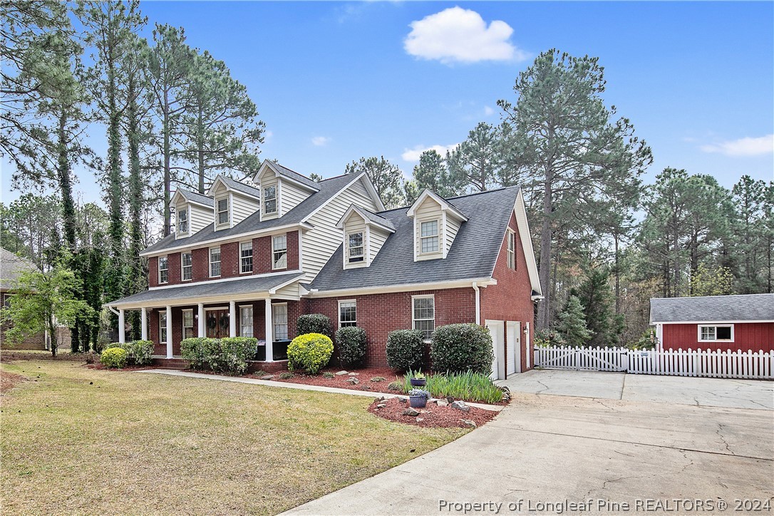 7833 Shuttle Road Fayetteville, NC 28311 - Photo 2 of 46 front view of a brick house with a yard