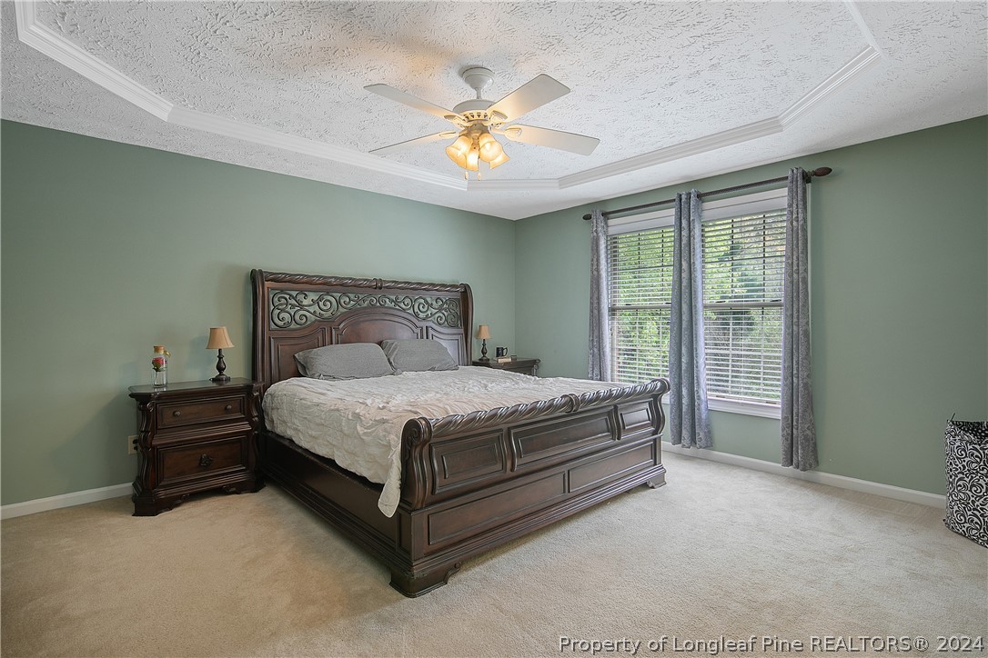 7833 Shuttle Road Fayetteville, NC 28311 - Photo 22 of 46 a bedroom with a bed and a chandelier