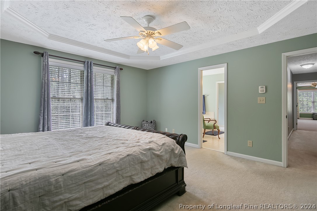 7833 Shuttle Road Fayetteville, NC 28311 - Photo 23 of 46 a bedroom with a bed and a chandelier