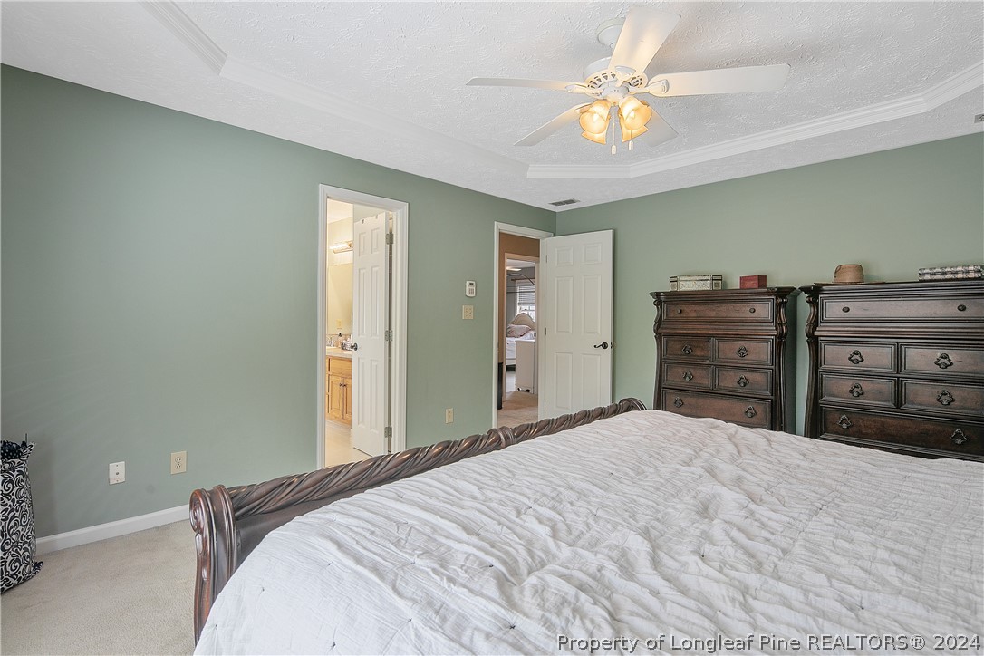 7833 Shuttle Road Fayetteville, NC 28311 - Photo 24 of 46 a bedroom with a bed and a chandelier