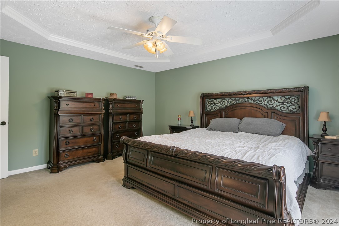 7833 Shuttle Road Fayetteville, NC 28311 - Photo 25 of 46 a bedroom with a bed and a chandelier