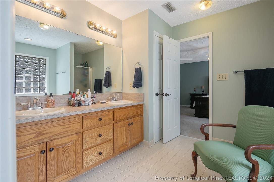 7833 Shuttle Road Fayetteville, NC 28311 - Photo 28 of 46 a spacious bathroom with a double vanity sink double and mirror