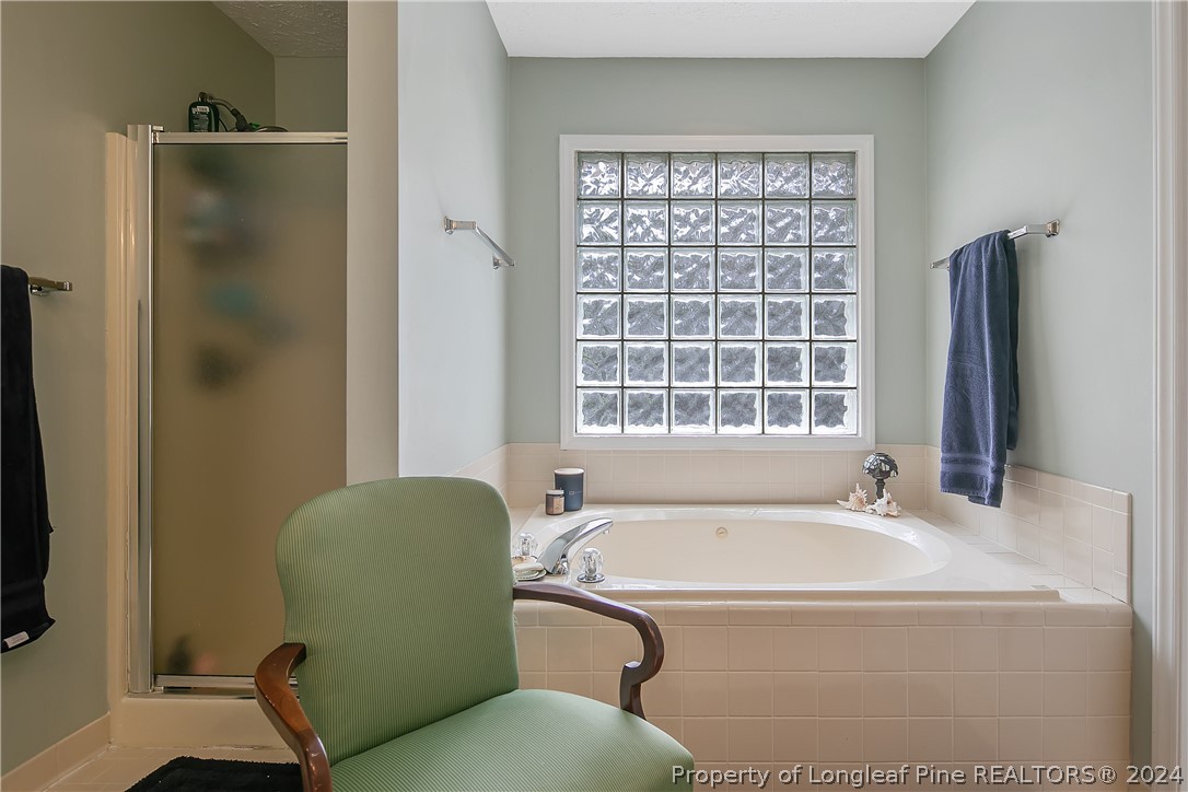 7833 Shuttle Road Fayetteville, NC 28311 - Photo 29 of 46 a bathroom with a tub and a sink