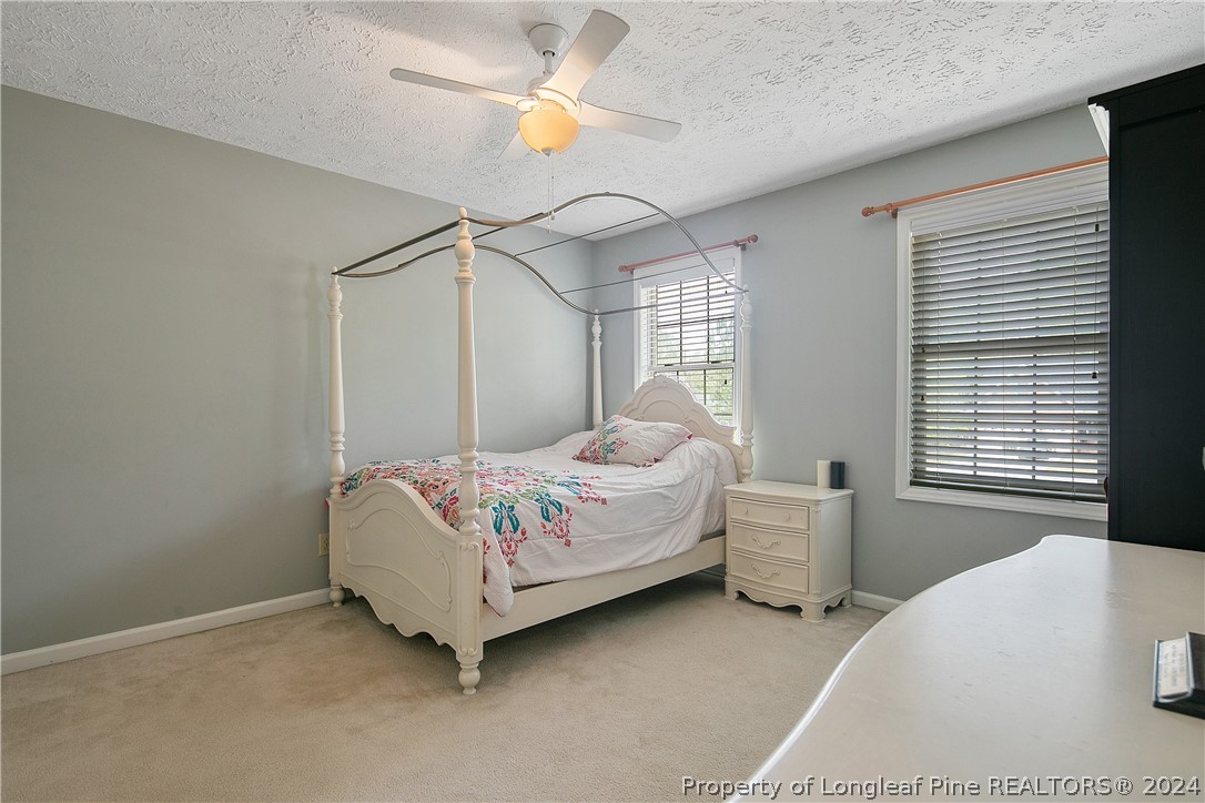7833 Shuttle Road Fayetteville, NC 28311 - Photo 35 of 46 a bedroom with a bed dresser and a window